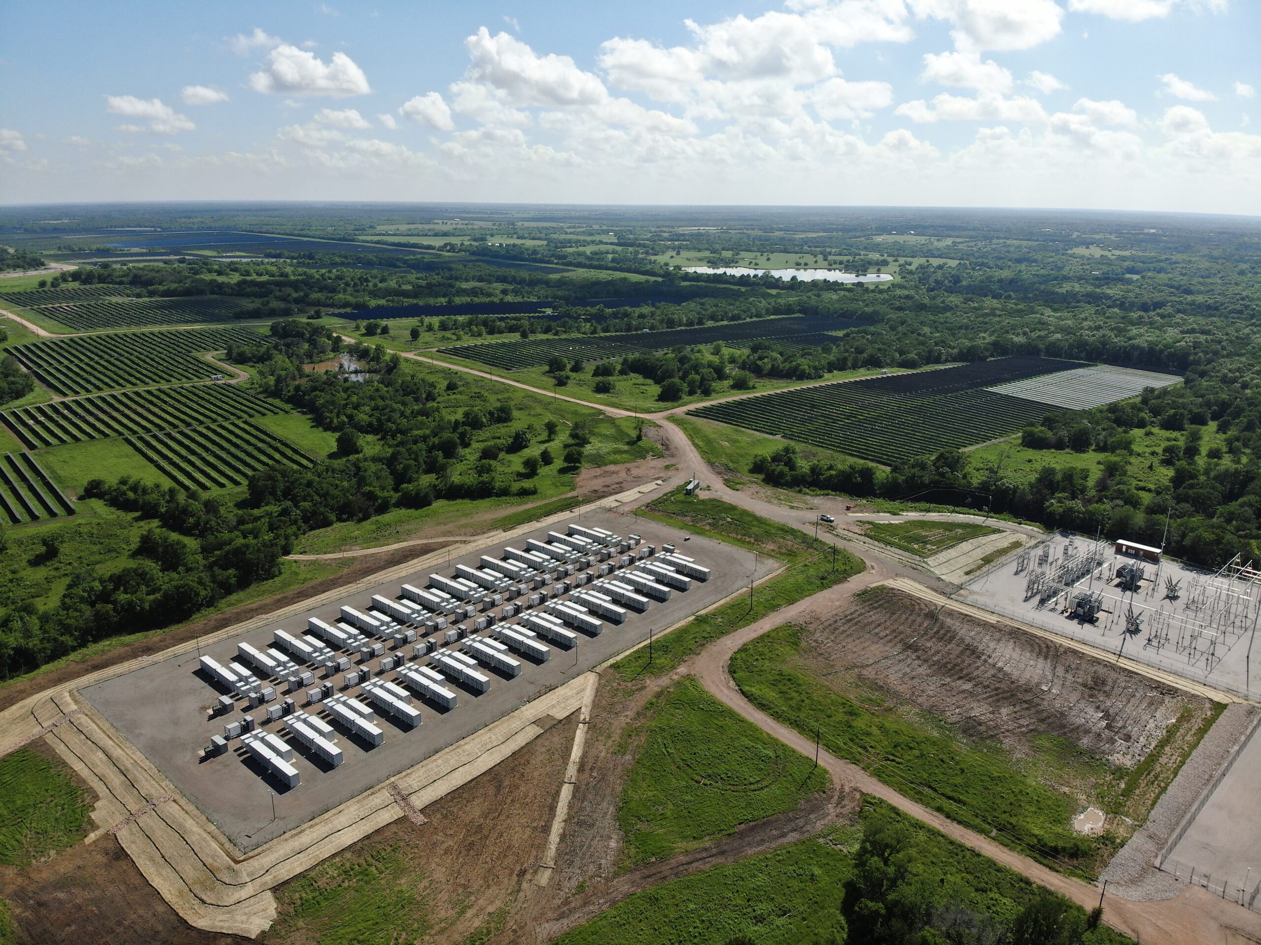 Rows of battery storage and thousands of solar panels