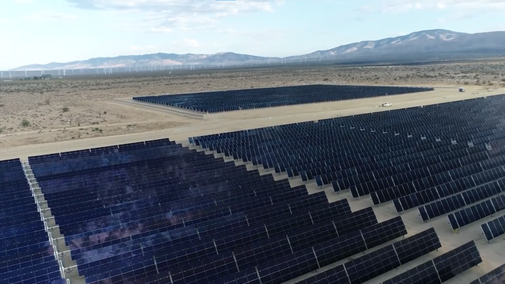 A desert landscape with several solar grids