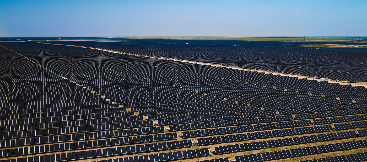 Thousands of solar panels on a stark vast landscape